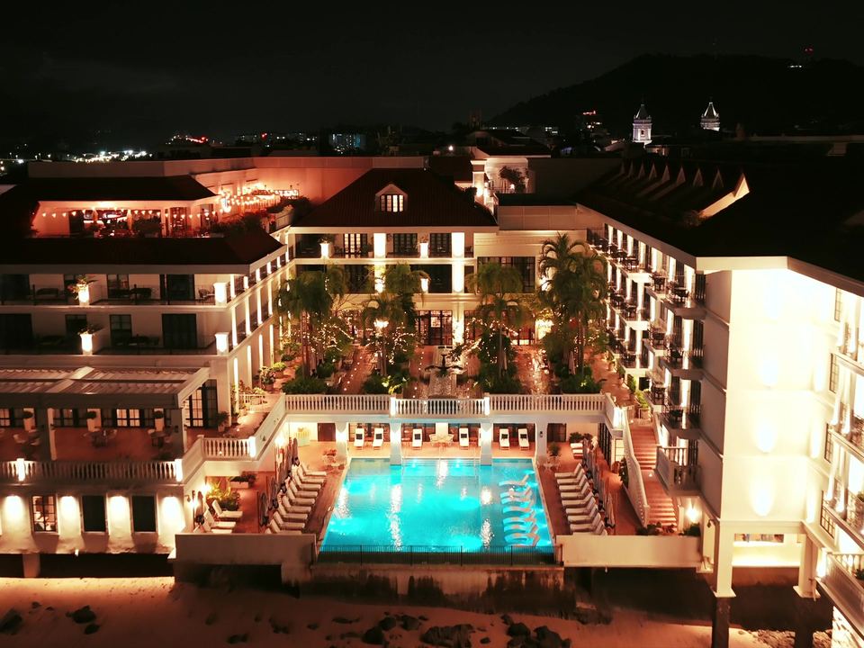 Ambara Bay at night: the lit resort around its pool courtyard, seen from the air.