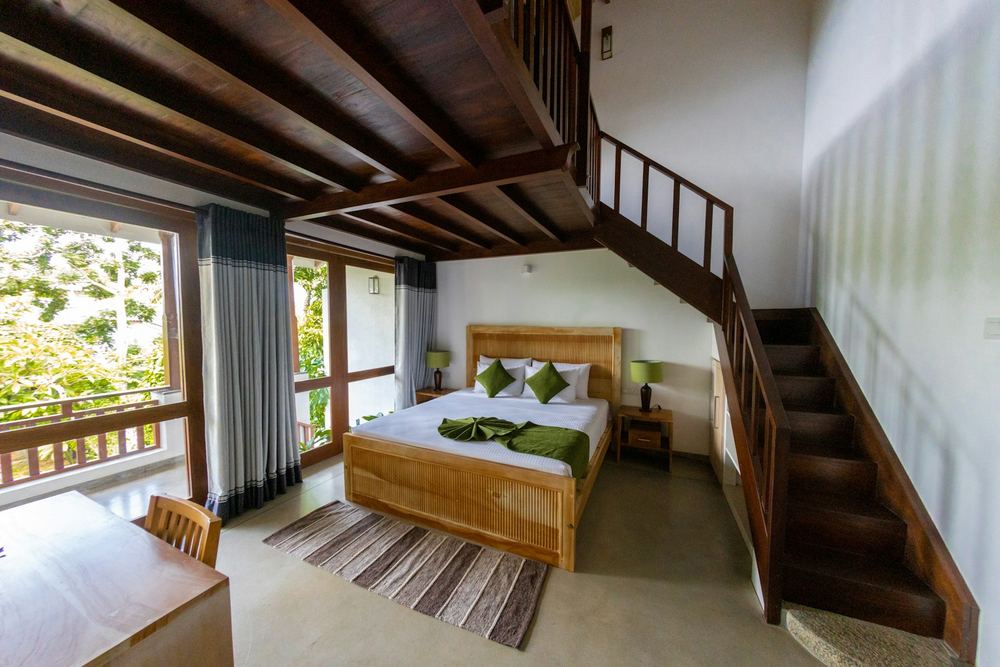 A timber bedroom with a staircase climbing to a loft.