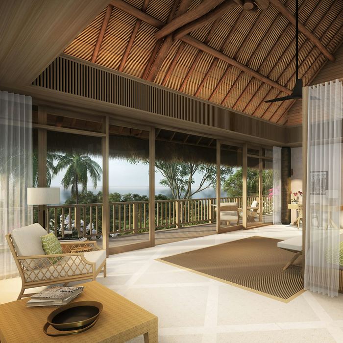 A bedroom under a thatched roof, glass doors open to palms and the garden.