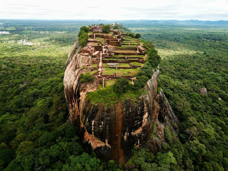 Sigiriya rock rising out of the forest, photographed from the air.
